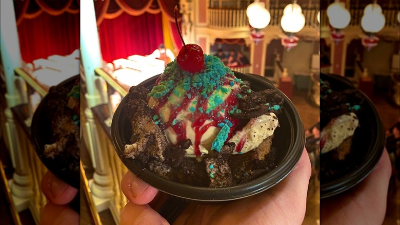 Hand holding ice cream sundae topped with Pop Rocks