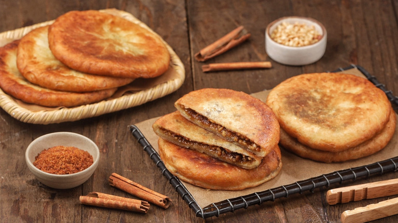 Korean hotteok pancakes with brown sugar and cinnamon filling on serving tray