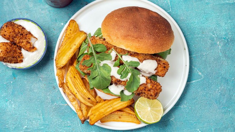 Fried fish sandwich with wedge fries