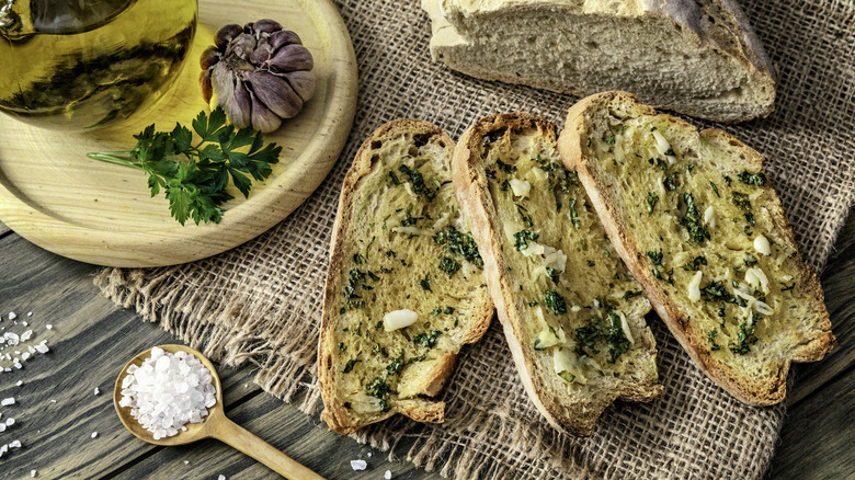 Garlic bread and ingredients on a table