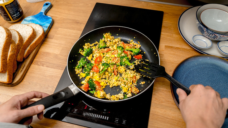 Chef in the kitchen preparing tofu scramble