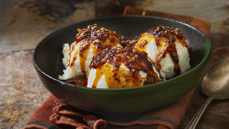 Bowl of vanilla ice cream topped with spicy chili crisp