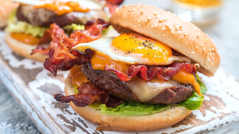 Cheeseburger with melted cheese, bacon, and a fried egg