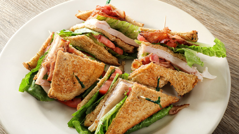 Club sandwich cut and served on plate