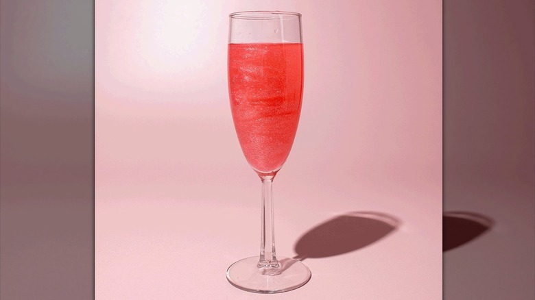 A pink cocktail featuring edible glitter