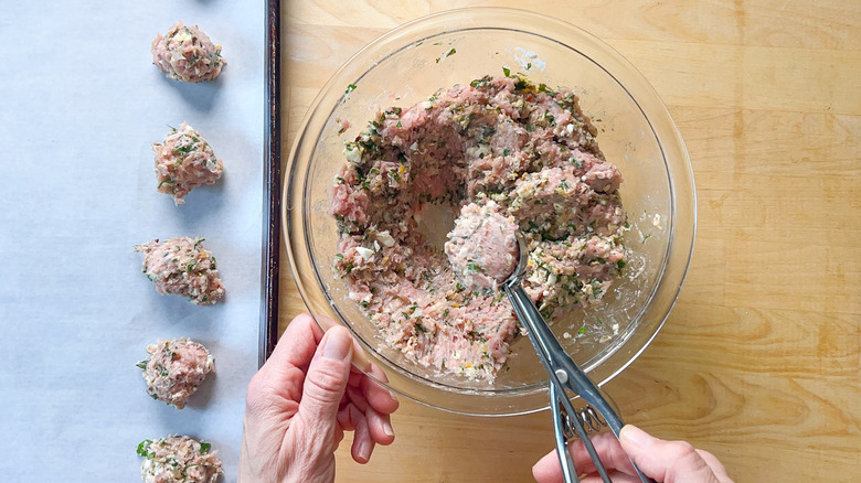 scooping out meatball mixture