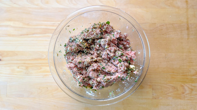 raw meat and herbs in bowl