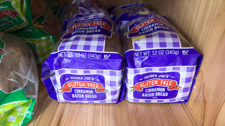 Two loaves of Trader Joe's gluten free cinnamon raison bread sit on a store shelf