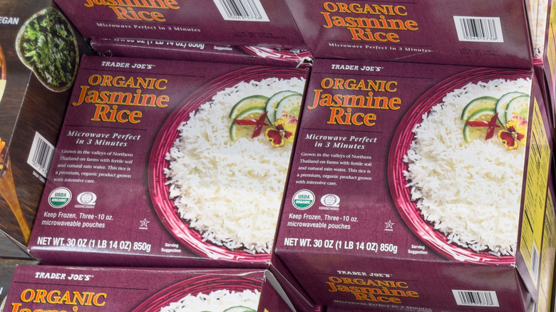 Boxes of Trader Joe's frozen organic jasmine rice sit stacked on top of each other