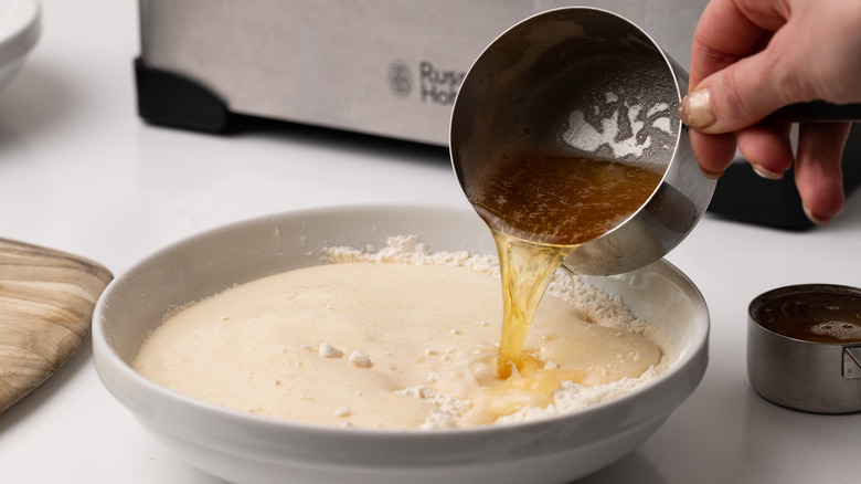 pouring beer into flour batter