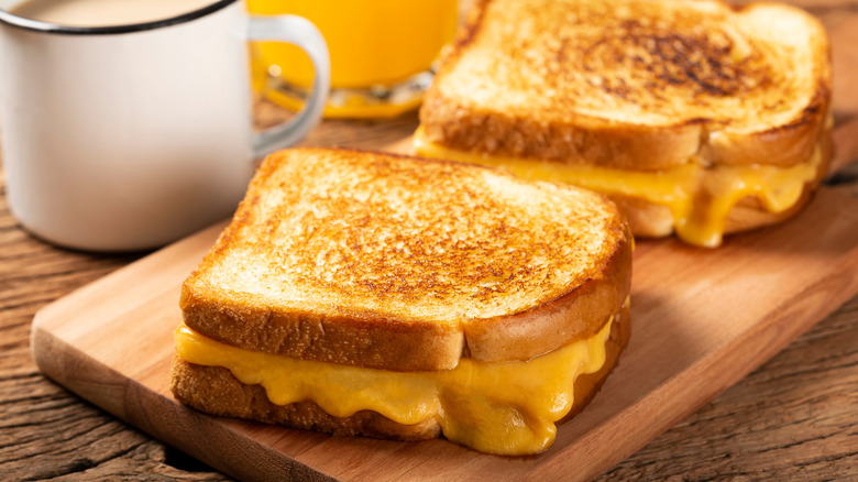 Two grilled cheese sandwiches and mug of coffee