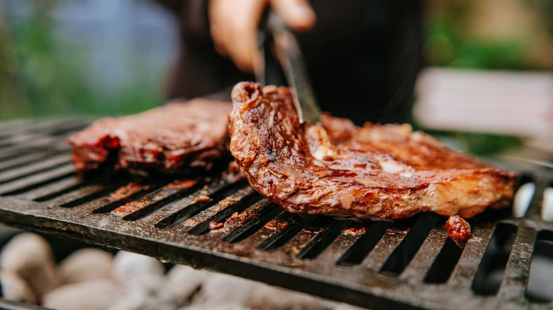 Flame grilling steaks.