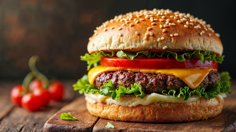 A hamburger on a wooden plate