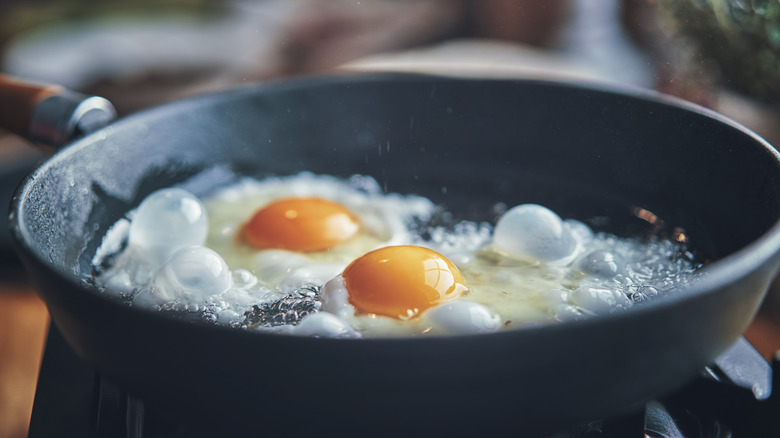 Eggs frying in a hot skillet