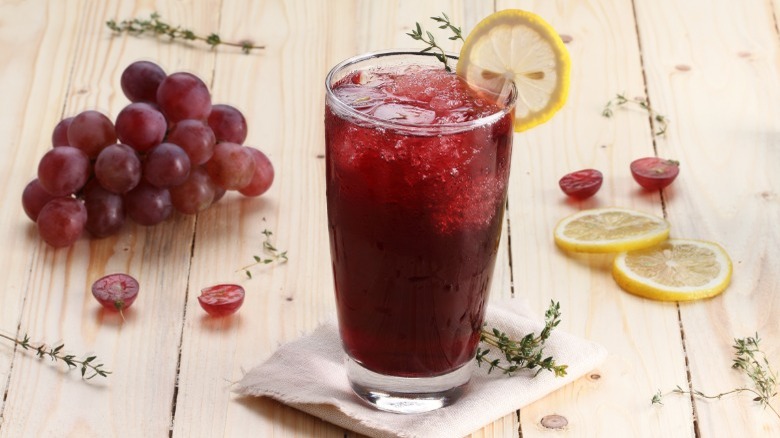 Grape-flavored beverage with a lemon wheel garnish 