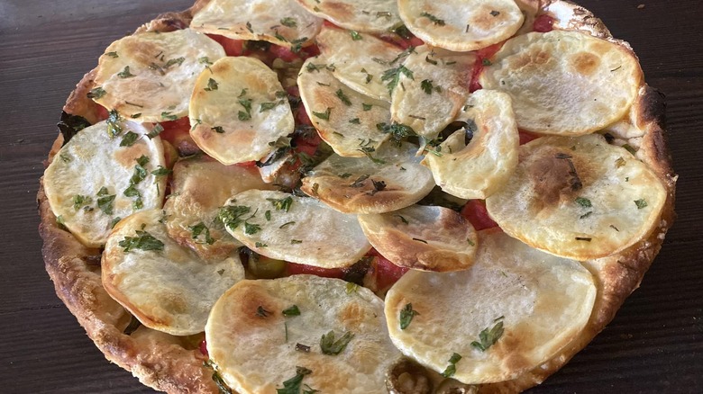 Traditional Gozo ftira pizza topped with sliced potatoes from Maxokk Bakery Malta