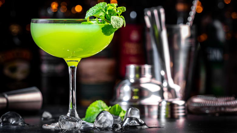 Lime green cocktail with mint garnish.