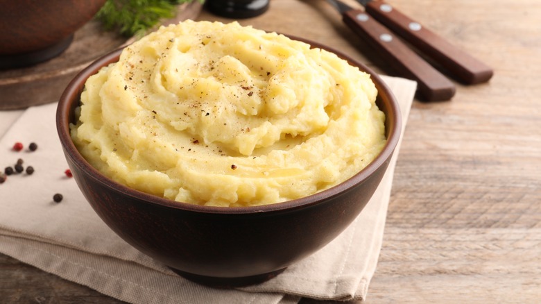 fluffy mashed potatoes served in wooden bowl