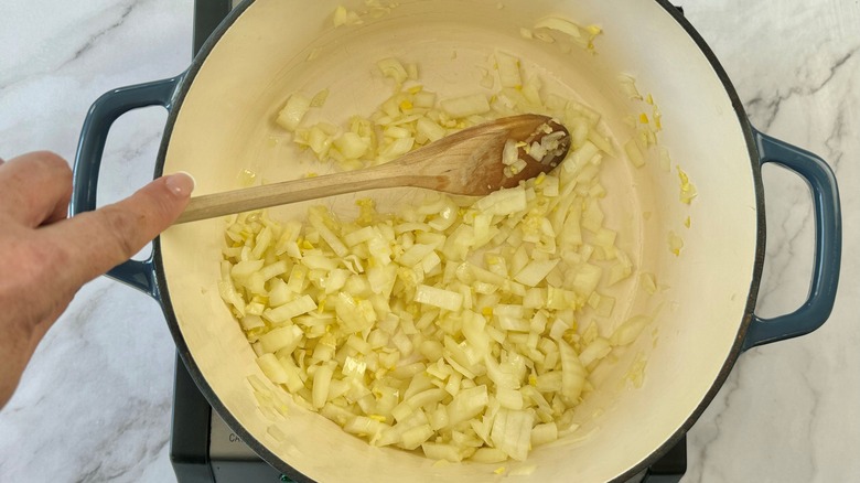 stirring onion and garlic sauteeing