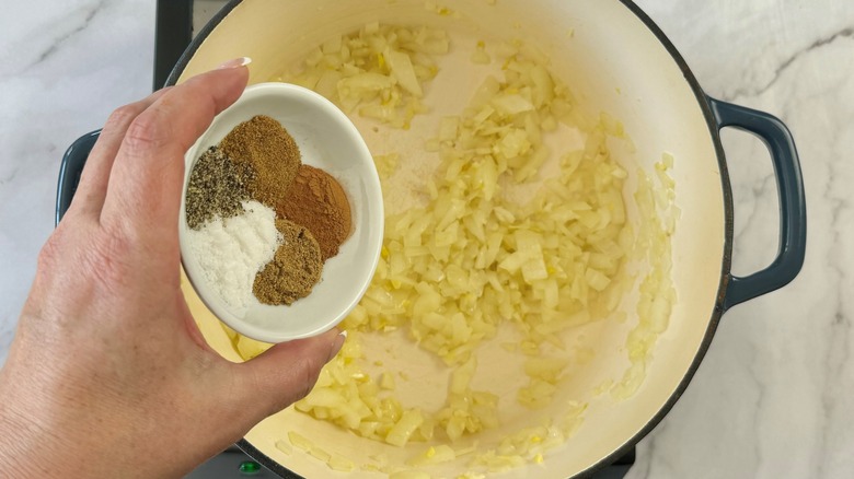 adding spices to sauteed alliums