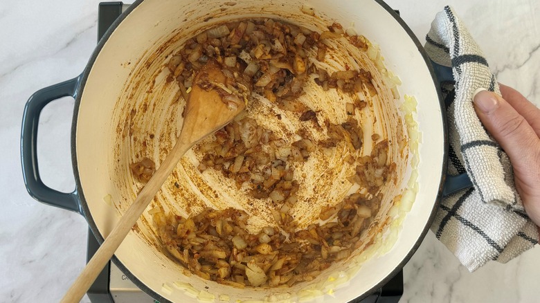 stirring sauteed alliums with spices