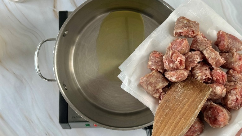 sausage chunks hovering over pot