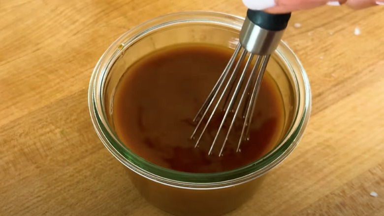 Whisking stir-fry sauce with a miniature whisk