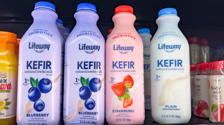 A selection of fruit flavored and plain kefir bottles at a store in California