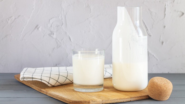 A jar of buttermilk with a glass