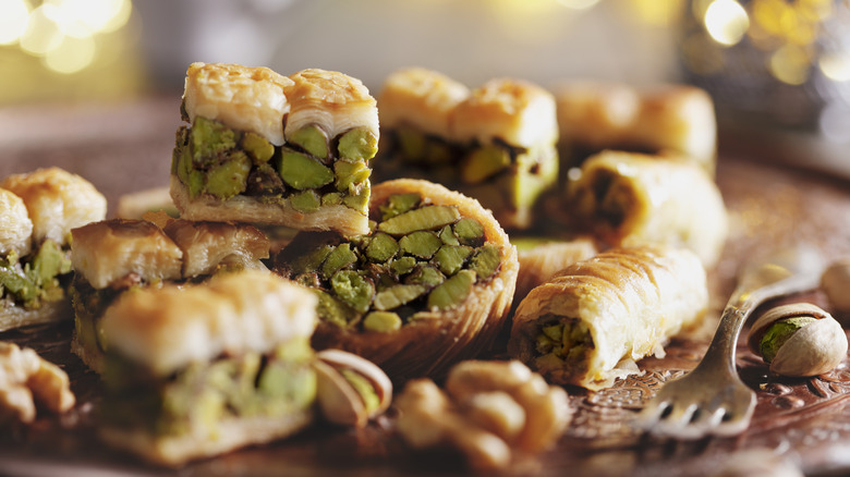 baklava stacked on top of each other with green nuts showing