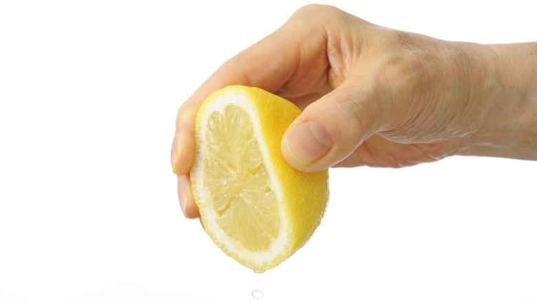 Hand squeezing lemon