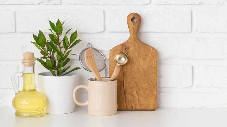 Wooden cutting board propped up in kitchen