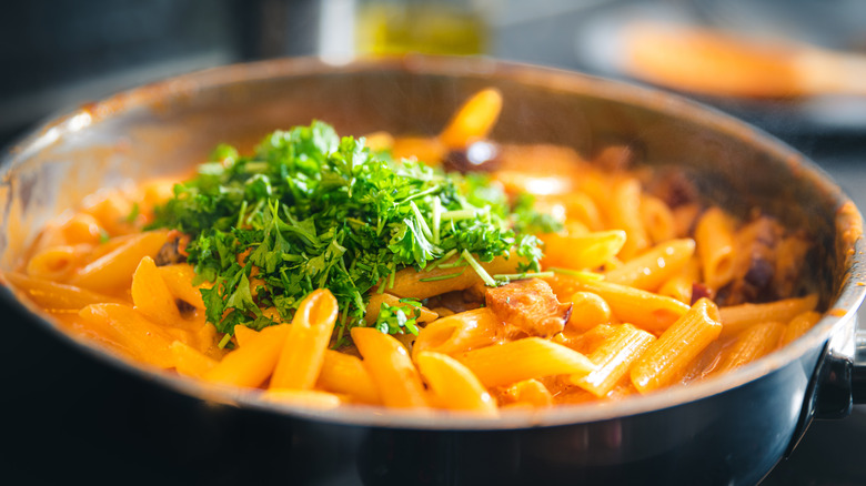 Penne a la vodka in a pot with parsley on top