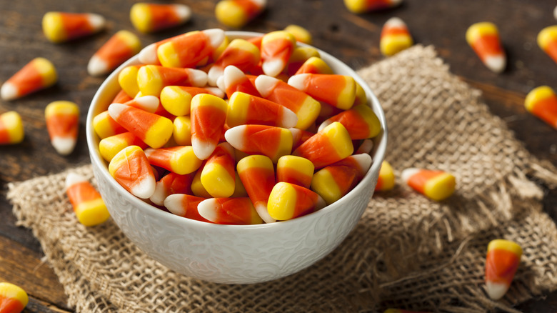 Halloween candy corn in a bowl on burlap cloth