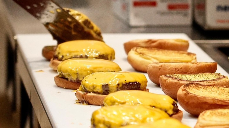 cheeseburgers being assembled