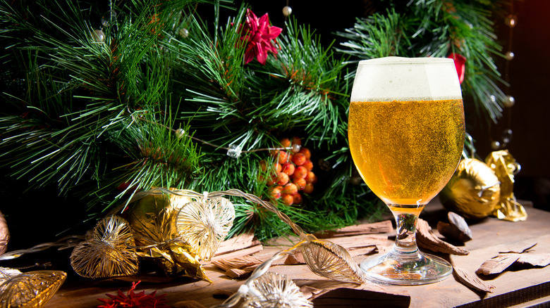 A glass of beer under a Christmas tree