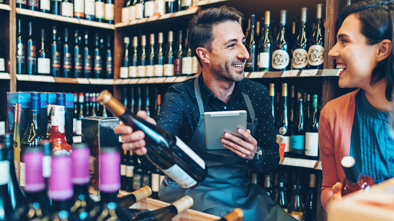 Man and woman in wine shop smiling