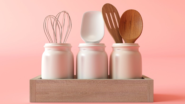 Kitchen utensils in white jars
