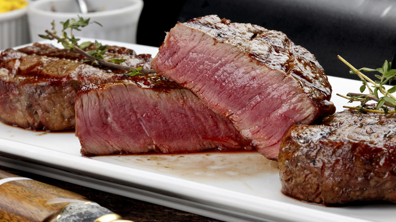 Cooked steaks cut open to show a rare interior