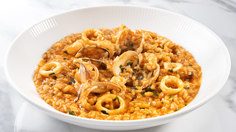 seafood risotto in a white bowl