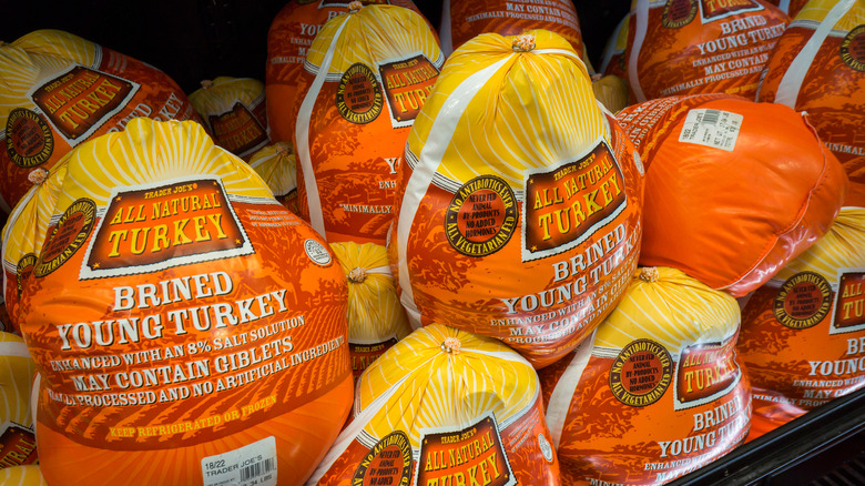 Pile of Trader Joe's all natural turkeys on a refrigerated shelf