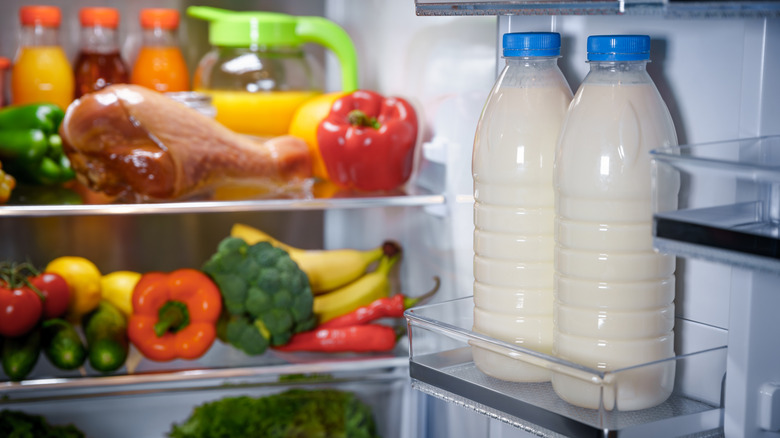 Products in the refrigerator. Bottles of milk in the fridge door