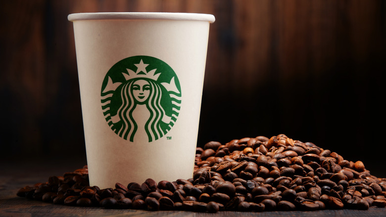 starbucks paper cup and coffee beans