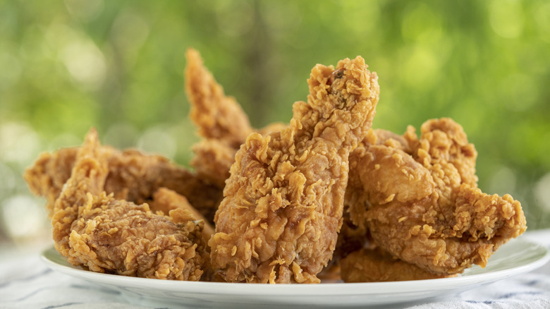 A plate of fried chicken wings and legs