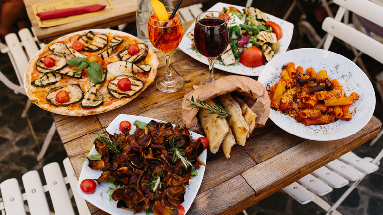 A table set with four different Italian dishes