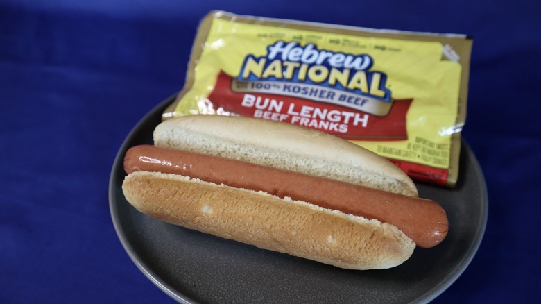 hot dog on plate in front of package