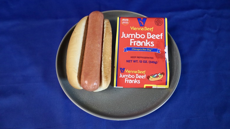 hot dog on bun next to label