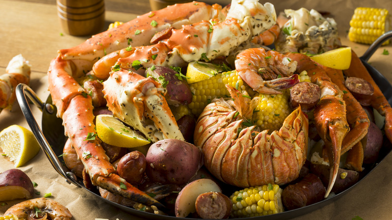 Seafood boil with lobster, crab, shrimp, sausage, potatoes, and corn