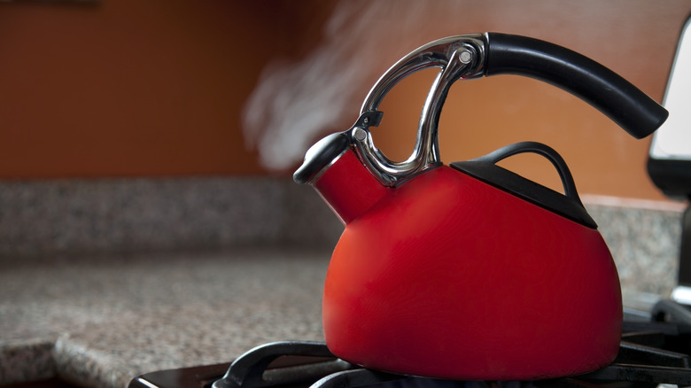 Red tea kettle with steam coming out