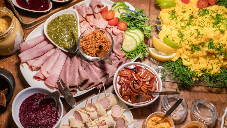 Scandinavian smörgåsbord spread with sauces, meats, and eggs